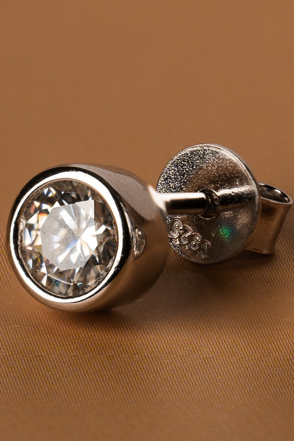 Veyelle Cercle moissanite bezel stud earrings in white gold — close-up