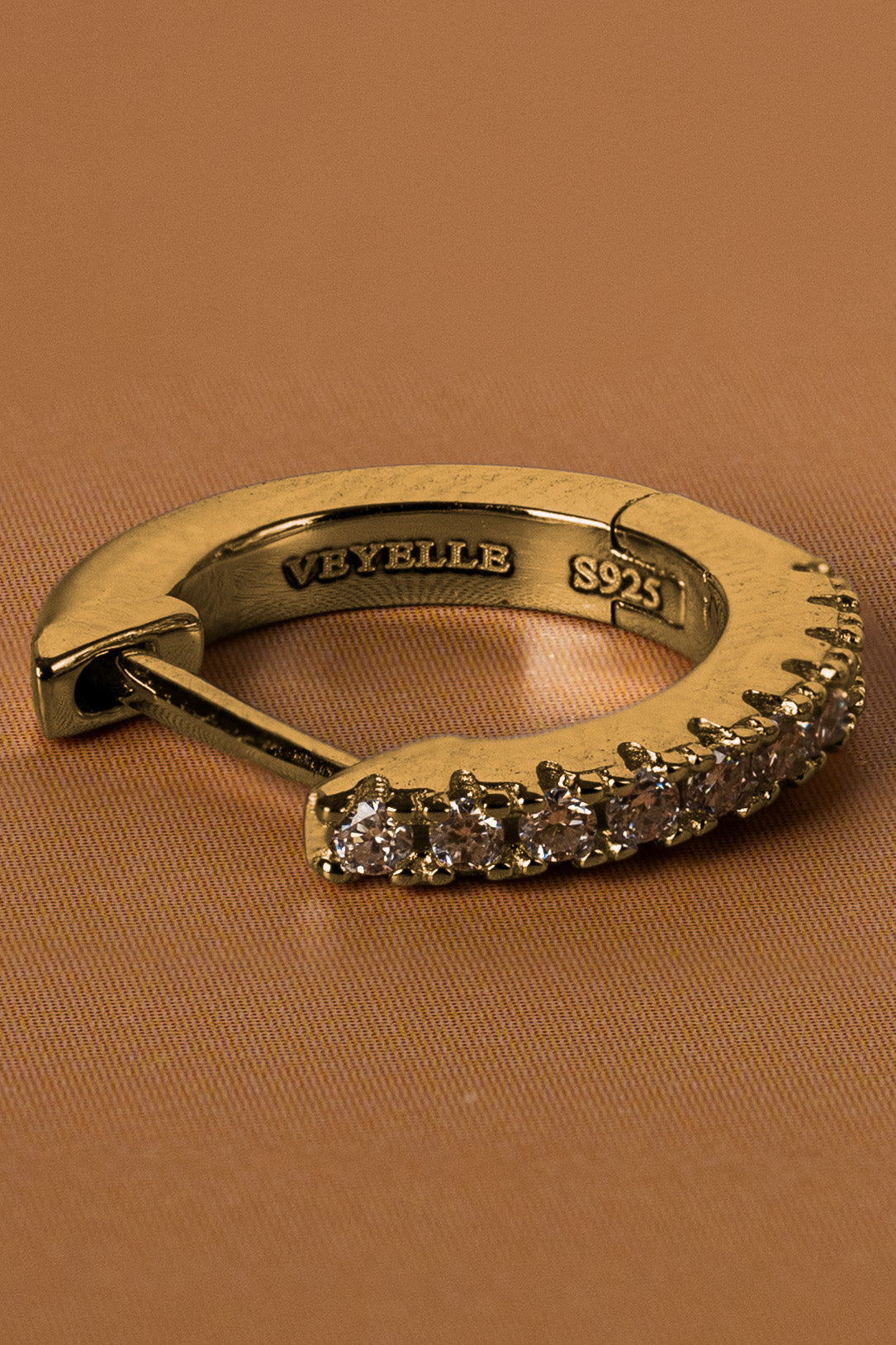 Veyelle Auris moissanite huggie earrings in golden gold — close-up