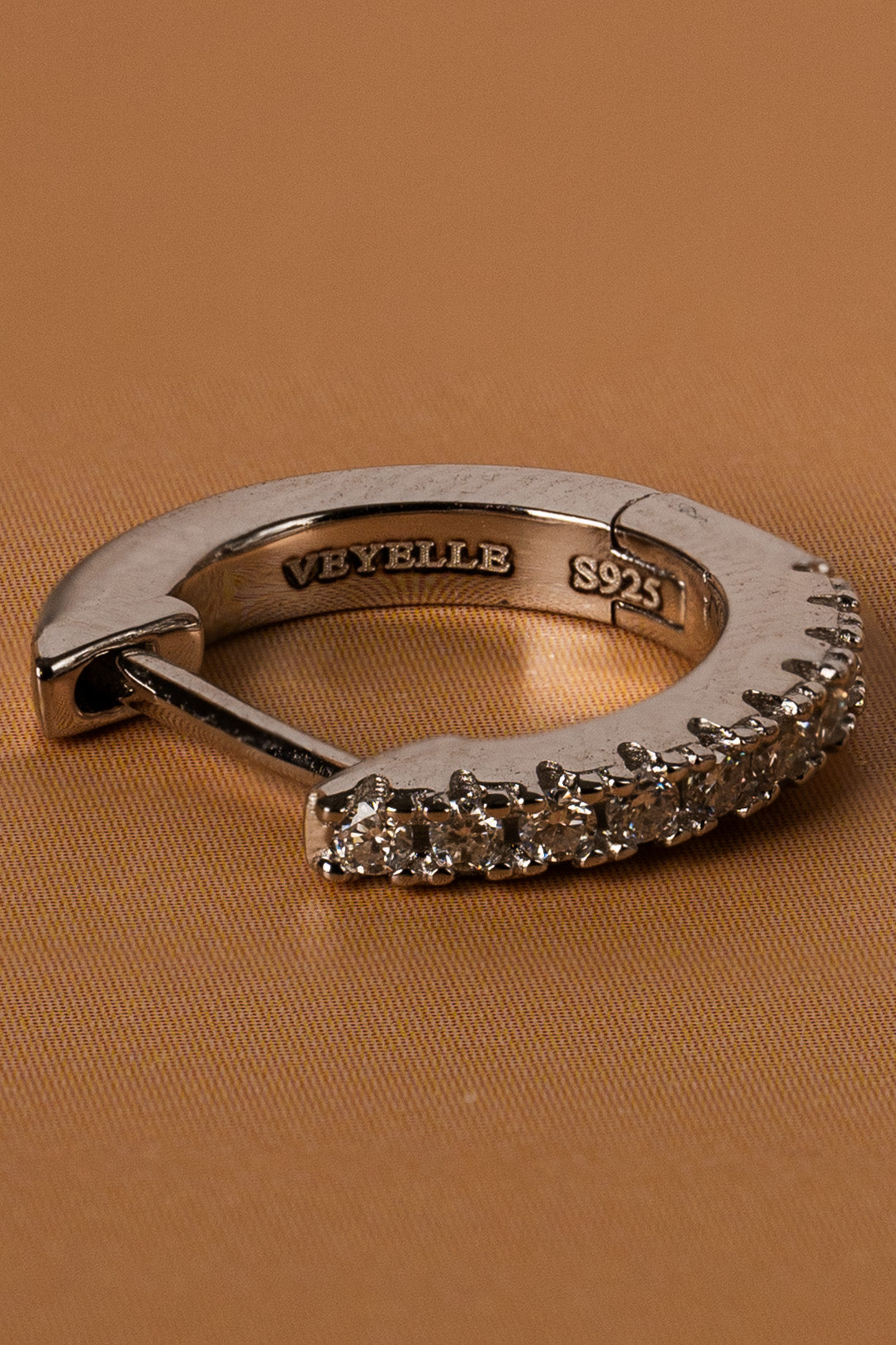 Veyelle Auris moissanite huggie earrings in white gold — close-up