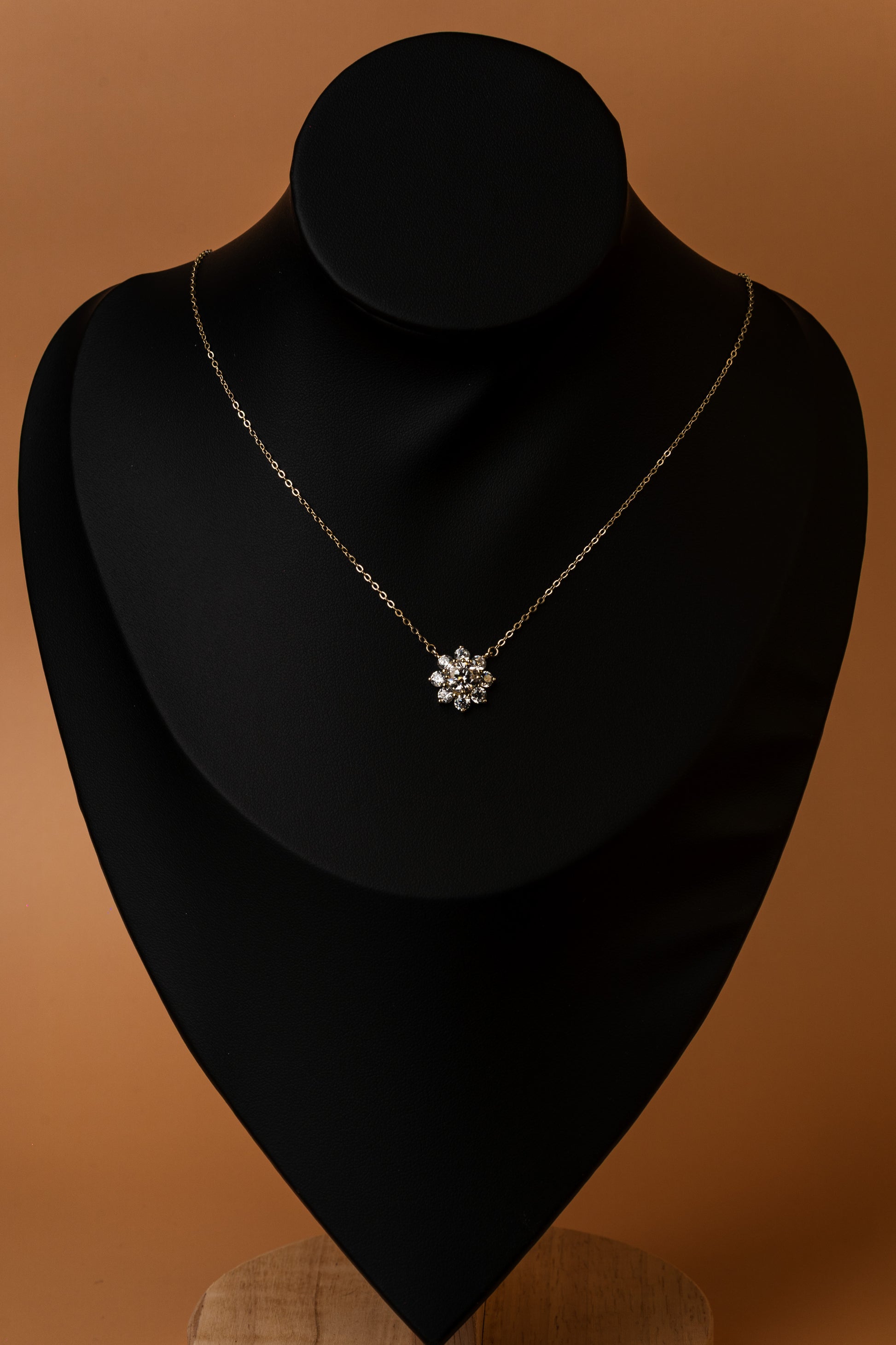Veyelle Neve moissanite snowflake necklace in golden gold — on model