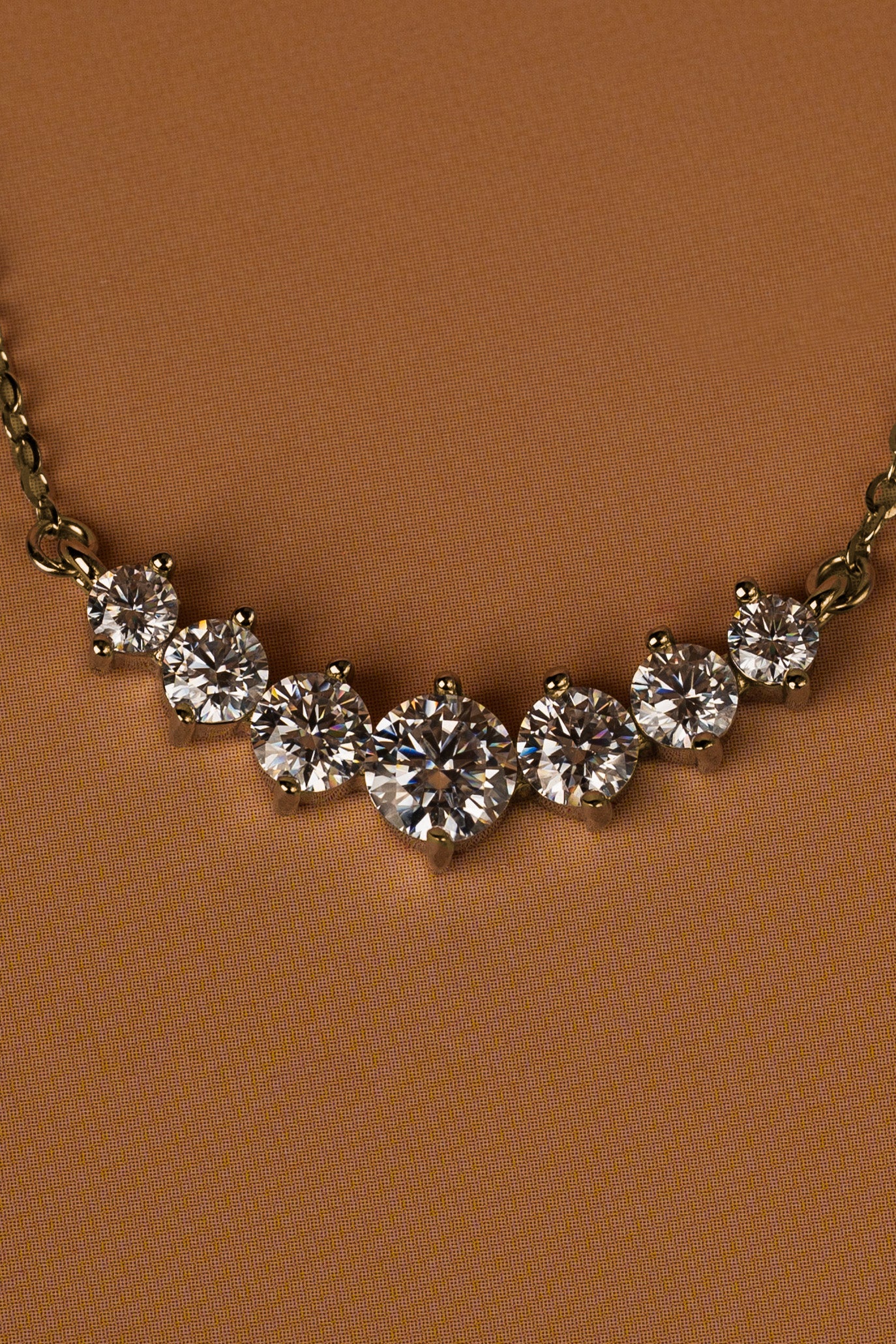 Veyelle Celestine moissanite graduated necklace in golden gold — close-up