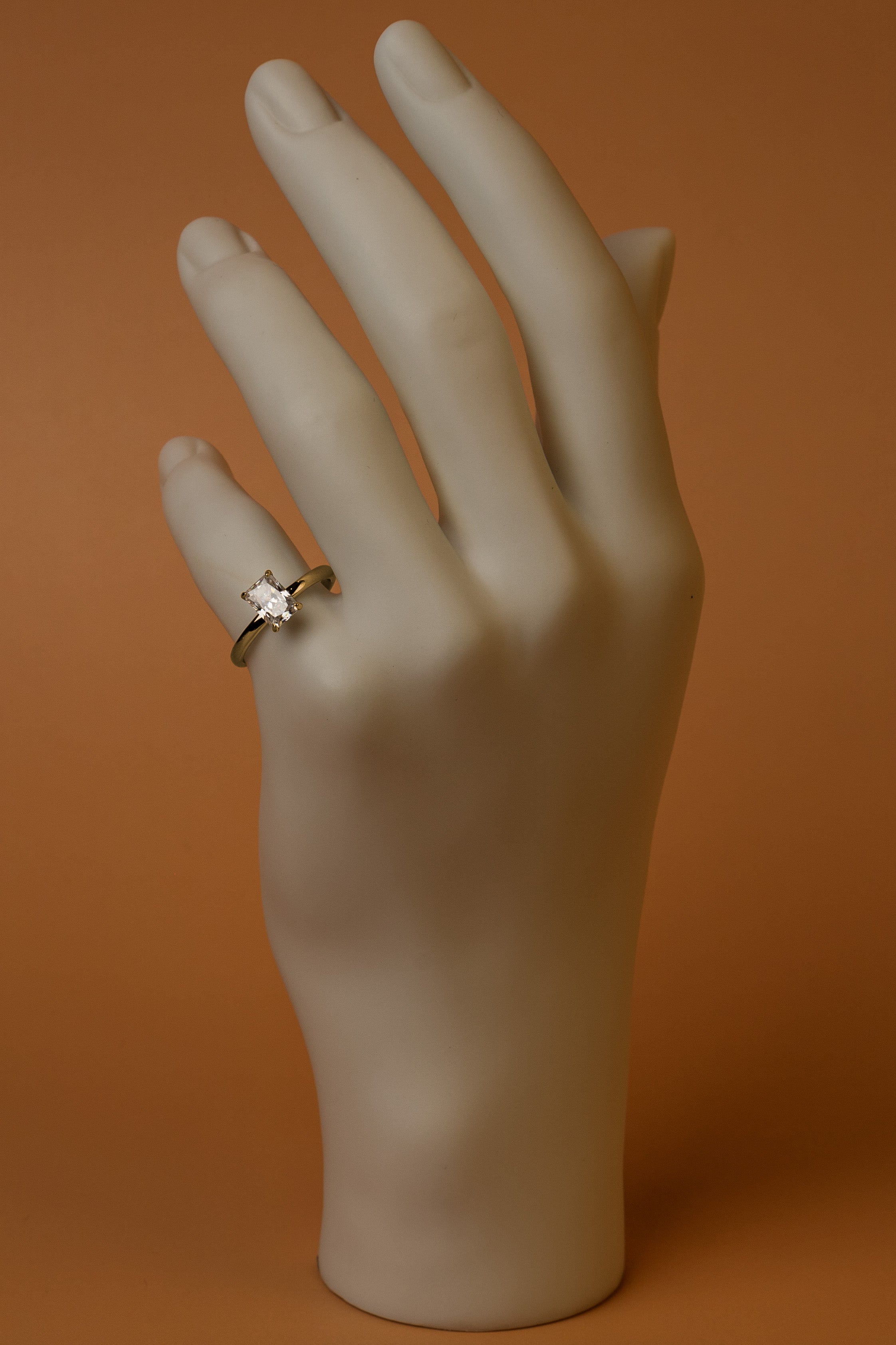 Veyelle Taille moissanite radiant ring in golden gold — on model