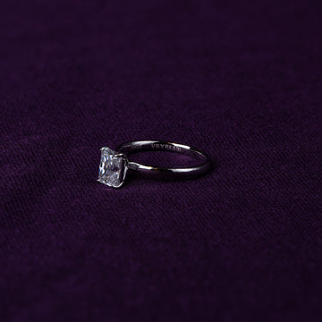 Veyelle Taille moissanite radiant ring in white gold on plum velvet background