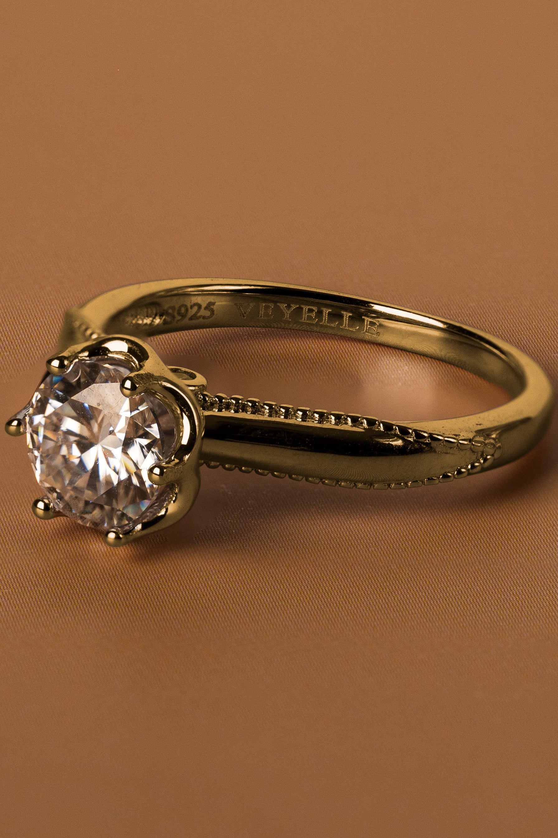 Veyelle Borde moissanite milgrain ring in golden gold — close-up